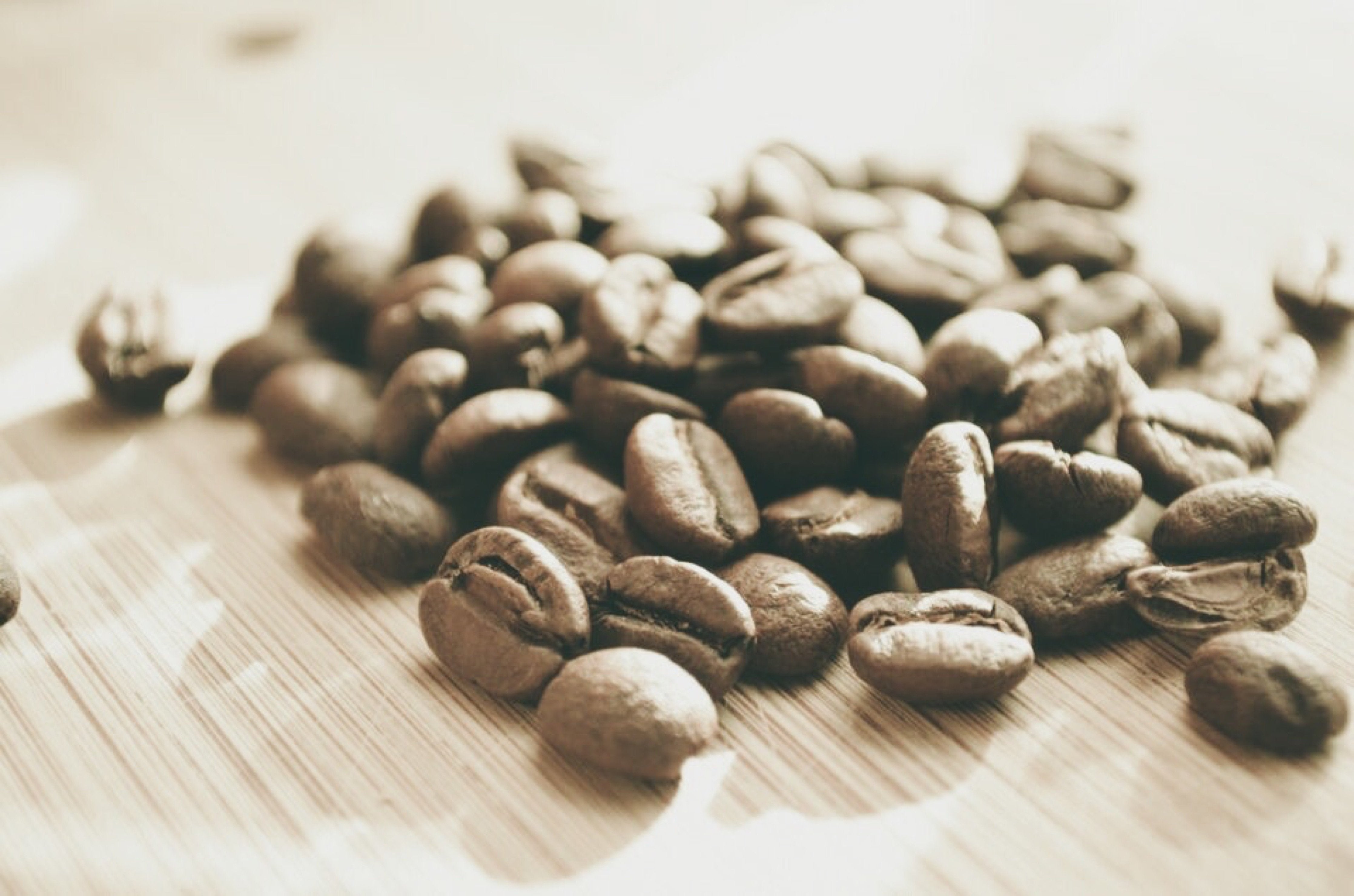 Lightly roasted specialty coffee beans laying on a table.