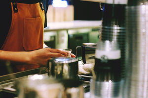 A barista preparing a craft coffee drink.